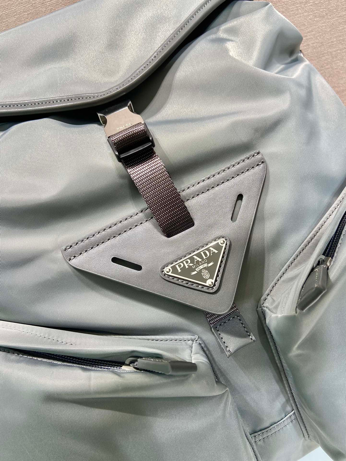PRADA TRIANGLE LOGO BACKPACK 45 IN ASH GRAY RE-NYLON