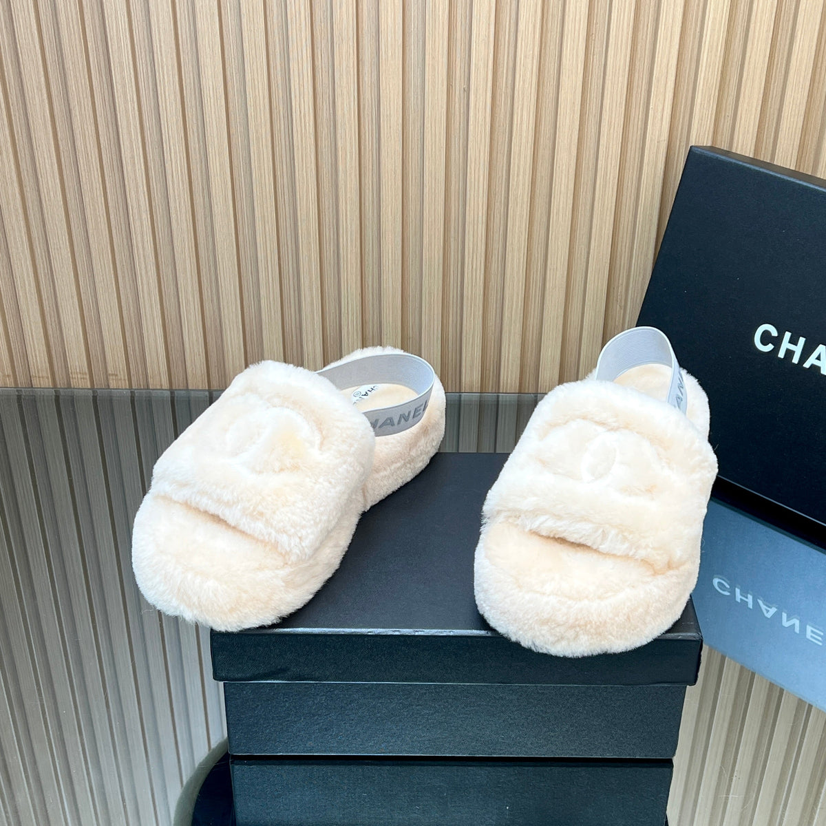 CHANEL 25S THICK-SOLED FURRY SLIPPERS WITH ELASTIC STRAPS IN BEIGE FUR