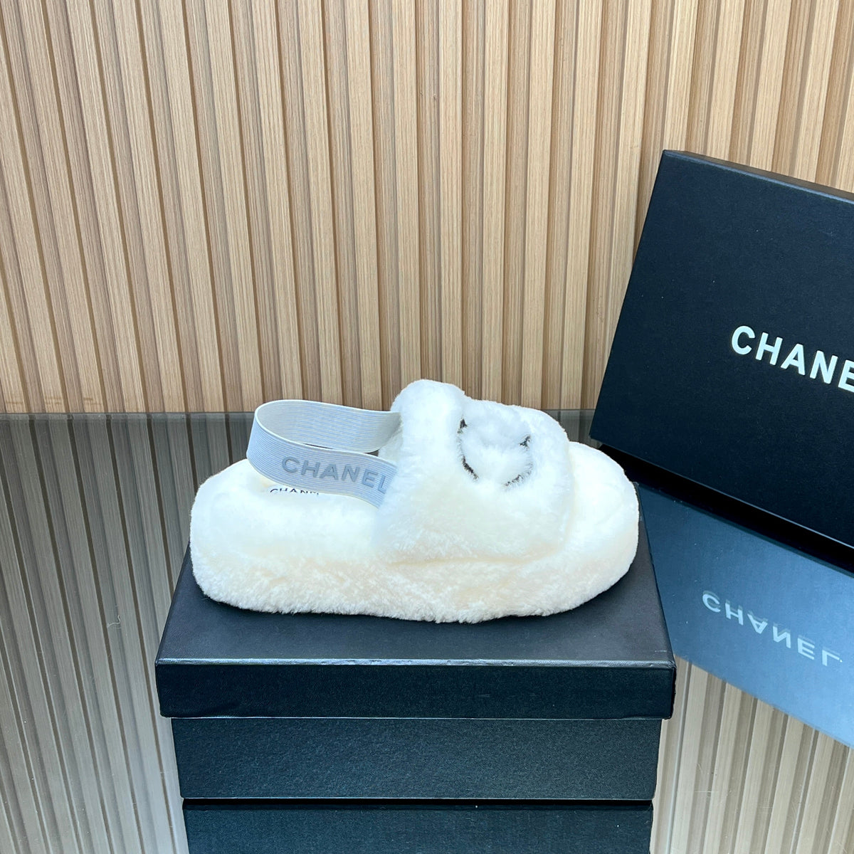 CHANEL 25S THICK-SOLED FURRY SLIPPERS WITH ELASTIC STRAPS IN WHITE FUR
