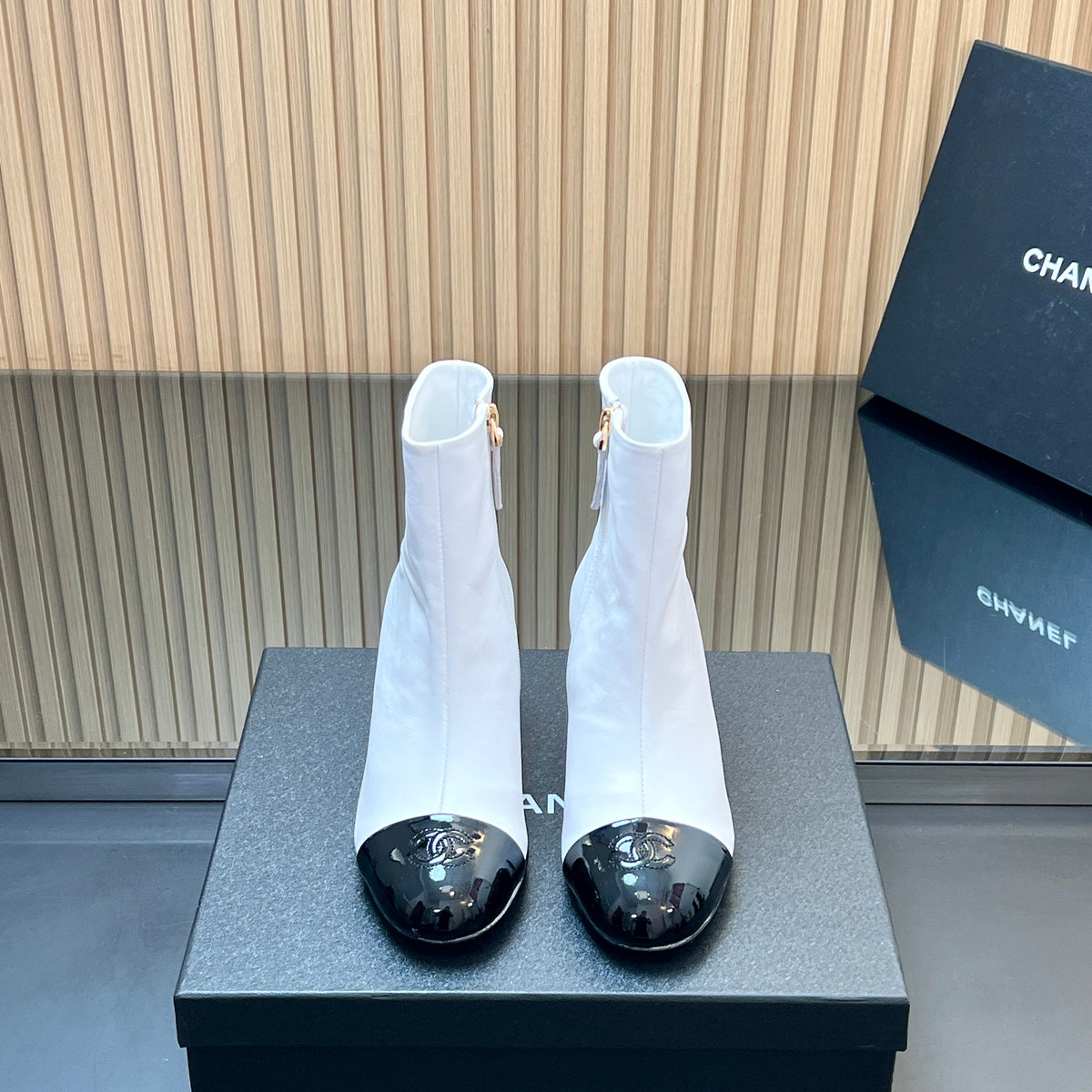 CHANEL 25S BOOTS WITH PATENT TOE CAP 50MM IN WHITE AND BLACK CALFSKIN